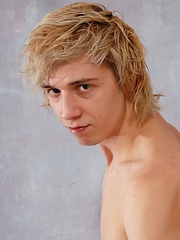 Cute blonde teen boy exposes his slim body